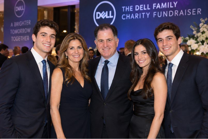 The Dell family standing together at a charity fundraiser.